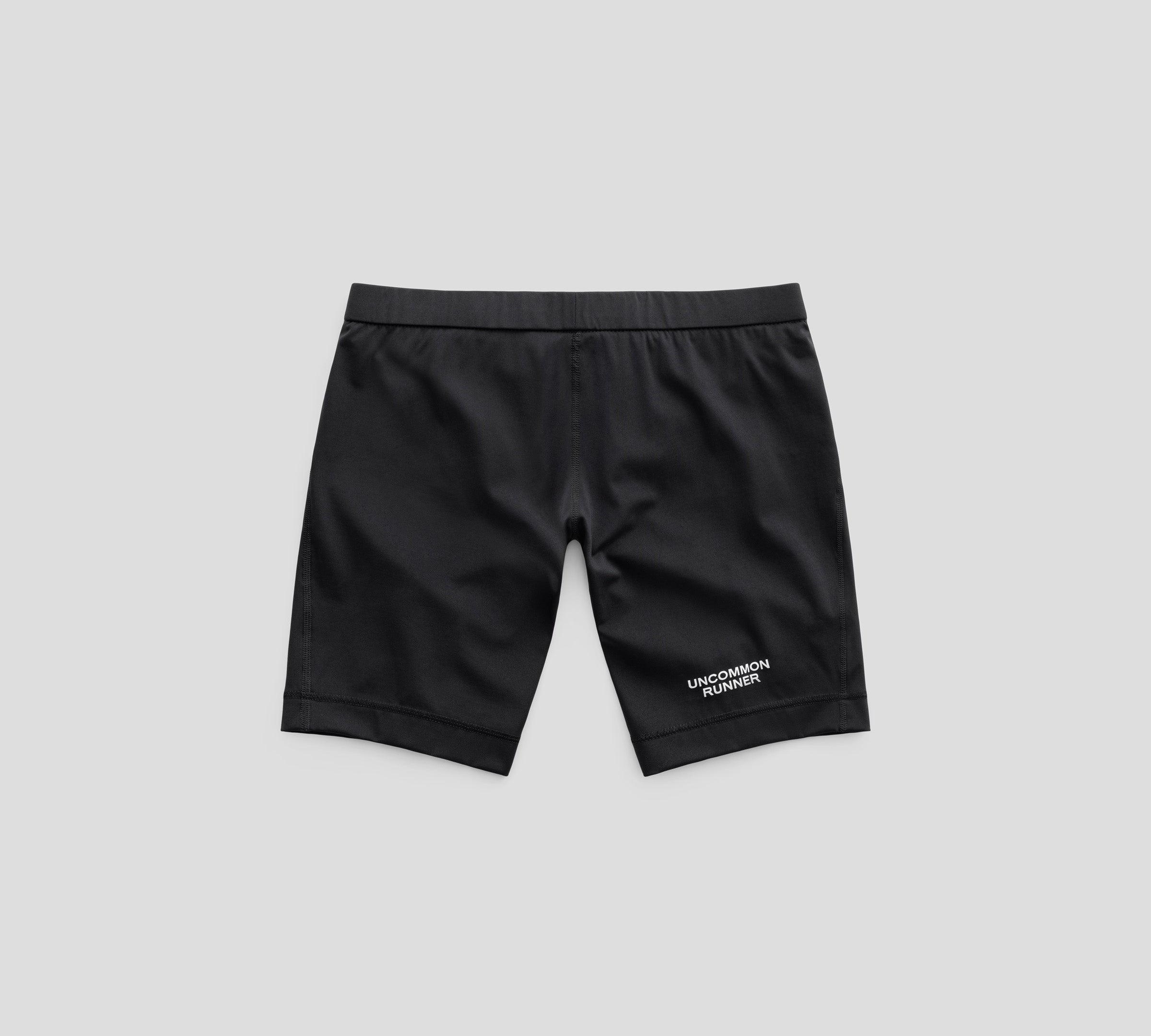 Black Valcora-8 half tights, front view with Uncommon Runner lettering.