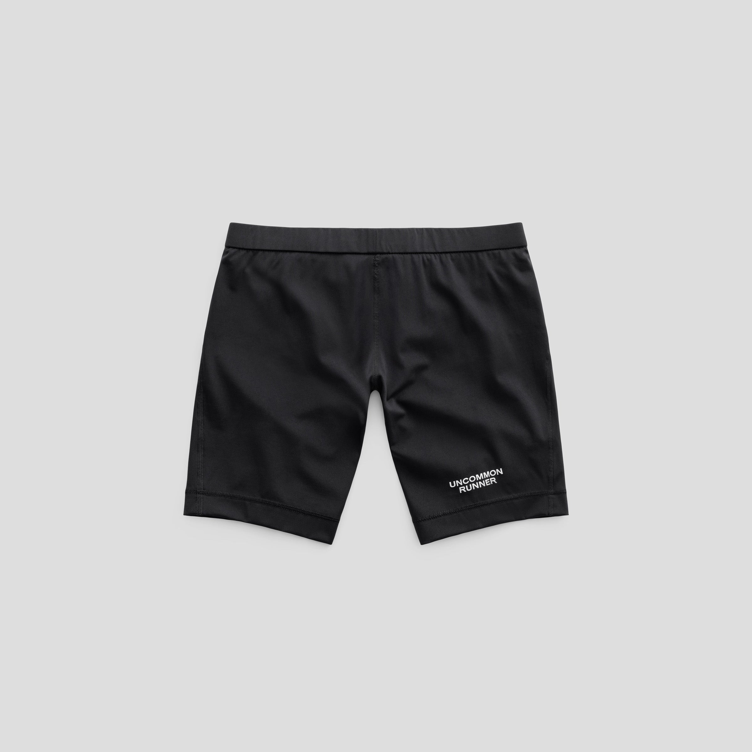 Black Valcora-8 half tights, front view with Uncommon Runner lettering.