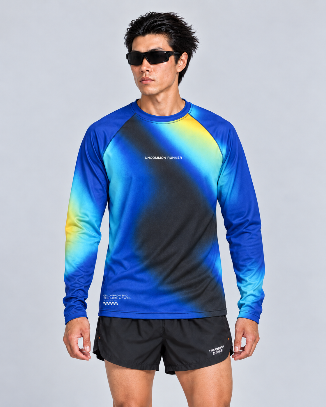 Front studio view of a male model wearing the Entering Flow State long-sleeve TempoTech running tee with black Phanto-3 race shorts