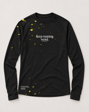 Front view of the Keep Running Weird long-sleeve TempoTech running tee in black with yellow splatter, white chest lettering and hem print